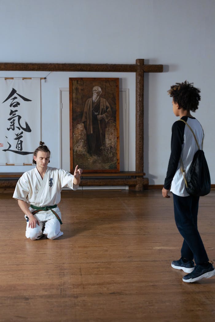 services-02 Martial arts instructor guides a student in a serene dojo for meditation and discipline.